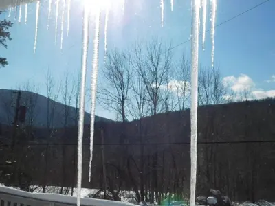 a view of icicles from a window with trees at Catskill Mountain Retreat in West Kill