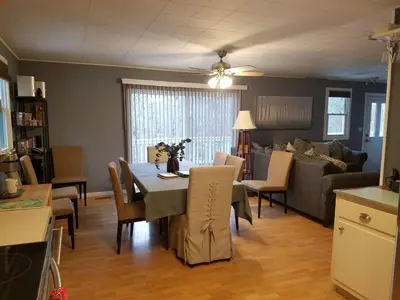 a kitchen and living room with a table and chairs at Catskill Mountain Retreat in West Kill