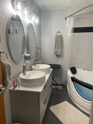 a bathroom with two sinks and a tub and mirror at Catskill Mountain Retreat in West Kill