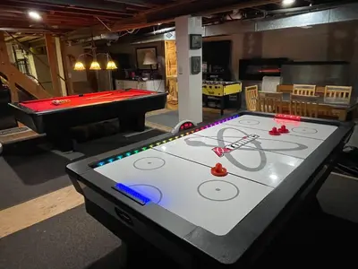 a ping pong table in a room with a pool table at Catskill Mountain Retreat in West Kill