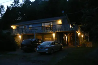 a house with two cars parked in front of it at night at Catskill Mountain Retreat in West Kill