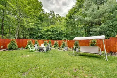 a backyard with a white tent and a table and chairs at Hot Tub, Game Room and Fire Pit Pocono Summit Home! in Pocono Summit