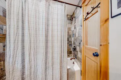 a bathroom with a shower curtain and a toilet at 219 Old Ark Road in Wilmington