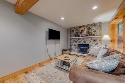 a living room with a couch and a stone fireplace at 219 Old Ark Road in Wilmington