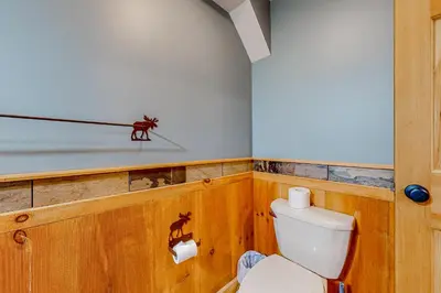 a bathroom with a toilet and a weapon on the wall at 219 Old Ark Road in Wilmington