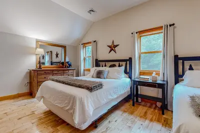 a bedroom with two beds and a mirror at 219 Old Ark Road in Wilmington