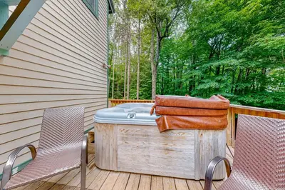 a hot tub and two chairs on a deck at 219 Old Ark Road in Wilmington