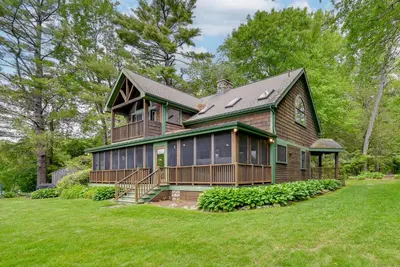 a large wooden house with a large yard at Lakefront Westhampton Cabin with Beach and Kayaks! in Westhampton