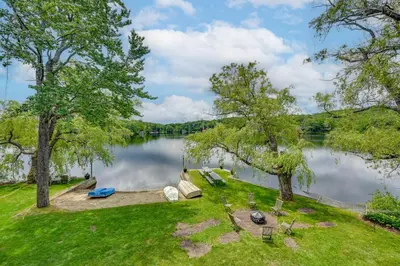 an aerial view of a lake with trees at Lakefront Westhampton Cabin with Beach and Kayaks! in Westhampton