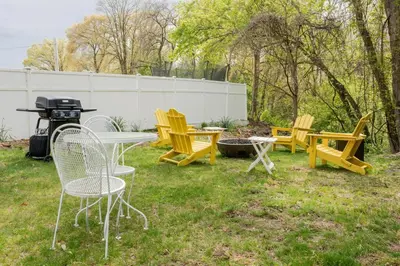 a group of chairs and a table and a grill at Campfire Cottage Fireplace, fire pit & no chores! in Kingston