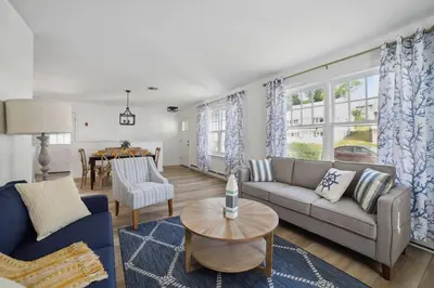 a living room with a couch and a table at Marine Theme - 4 BR - Backyard - Fire pit in Bridgeport