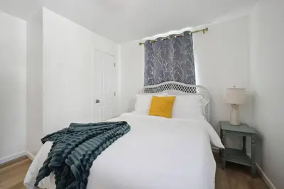 a bedroom with a large white bed and a window at Marine Theme - 4 BR - Backyard - Fire pit in Bridgeport