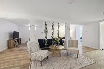 a living room with a couch and a table and chairs at Marine Theme - 4 BR - Backyard - Fire pit in Bridgeport