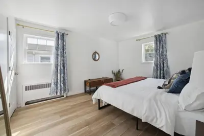 a white bedroom with a bed and a window at Marine Theme - 4 BR - Backyard - Fire pit in Bridgeport
