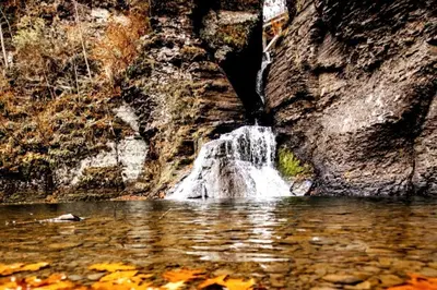 a waterfall in the middle of a pool of water at Mountain-Top-Hideaway Stay in a log cabin on a private rd! Swim, hike, explore a true mountain experience in North Blenheim