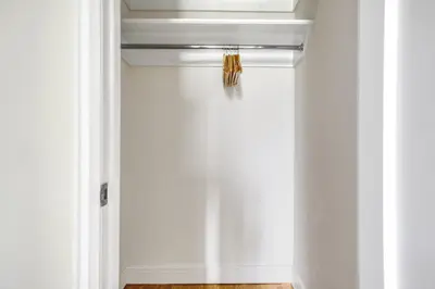 a hallway with white walls and a ceiling with a light at Upper W Side 1BR w Gym by Lincoln Sq NYC-331 in New York
