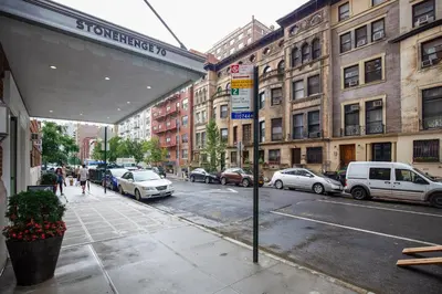 a city street with cars parked on the street at Upper W Side 1BR w Gym by Lincoln Sq NYC-331 in New York