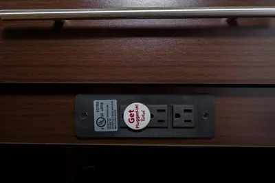 a digital clock sitting on a wooden shelf at Red Roof Inn PLUS+ Poughkeepsie in Poughkeepsie