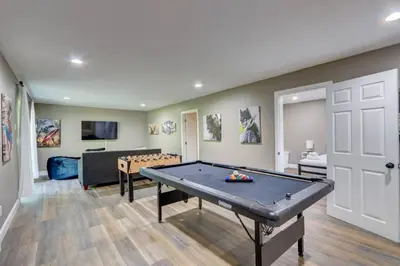 a living room with a ping pong table in it at Cozy Chalet Game Rm and Fireplace in East Stroudsburg