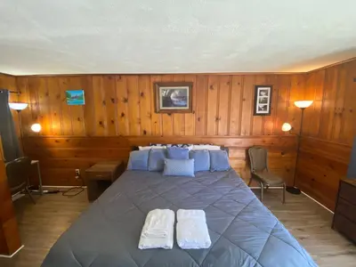 a bedroom with a bed with two towels on it at Heart of the Berkshires Motel in Pittsfield