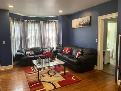 a living room with a leather couch and a table at fashionably cozy place in Meriden