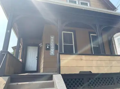 a house with a sign on the front of it at fashionably cozy place in Meriden