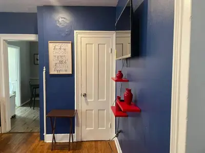 a blue room with a white door and red shelves at fashionably cozy place in Meriden