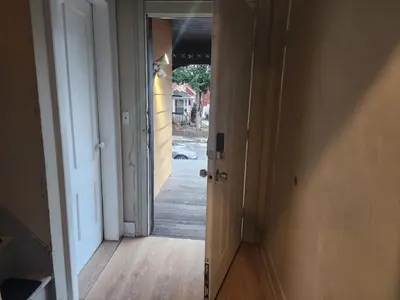 an open door to a hallway with an open door at fashionably cozy place in Meriden
