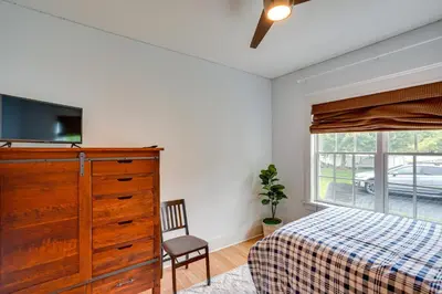 a bedroom with a bed and a dresser with a tv at Stockbridge Retreat with Pool and Hot Tub! in Stockbridge