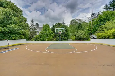 a basketball court with a hoop on top of it at Stockbridge Retreat with Pool and Hot Tub! in Stockbridge