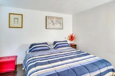 a bedroom with a bed with blue and white stripes at Cozy Berkshires Vacation Rental Near Hiking! in Chester