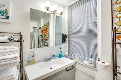 a white bathroom with a sink and a mirror at Cozy Berkshires Vacation Rental Near Hiking! in Chester
