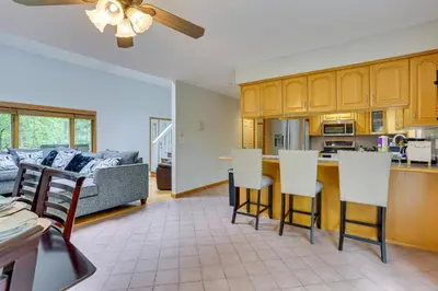 a kitchen and a living room with a couch at Bushkill Home with Access to Pools and Tennis Courts! in Bushkill