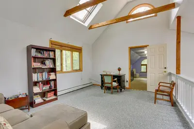 a living room with a couch and a book shelf at Bushkill Home with Access to Pools and Tennis Courts! in Bushkill