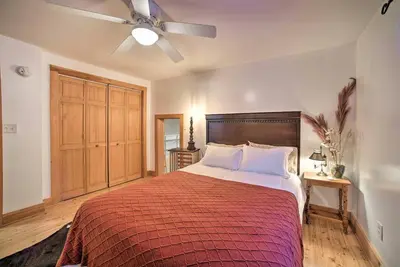 a bedroom with a large bed with a ceiling fan at Catskills Farmhouse and Spa in Harpersfield