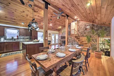 a kitchen and dining room with a wooden table and chairs at Catskills Farmhouse and Spa in Harpersfield