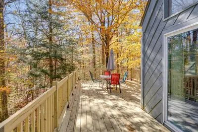a wooden deck with a table and chairs on it at Wilmington Vacation Rental Near Hiking and Skiing! in Wilmington
