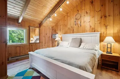 a bedroom with a bed in a wooden wall at Wilmington Vacation Rental Near Hiking and Skiing! in Wilmington