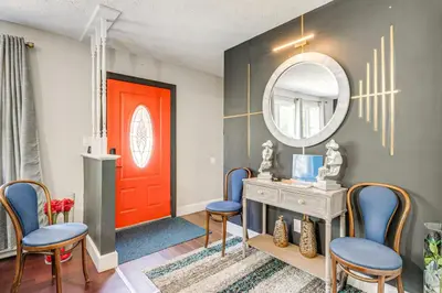 a room with a red door and chairs and a mirror at A Time to Remember Home in Tobyhanna with Pool! in Tobyhanna