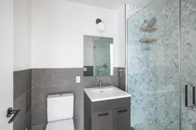 a bathroom with a toilet and a sink and a shower at East Village 2br w doorman wd nr Union Square NYC-1185 in New York