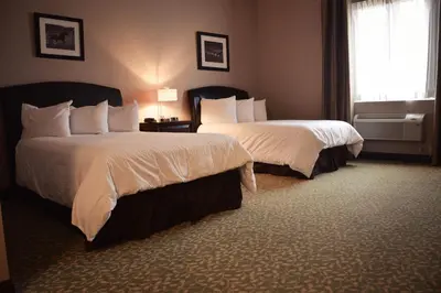 a hotel room with two beds and a window at Belvedere Inn Schenectady - Albany in Schenectady