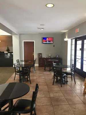 a restaurant with tables and chairs in a room at Belvedere Inn Schenectady - Albany in Schenectady