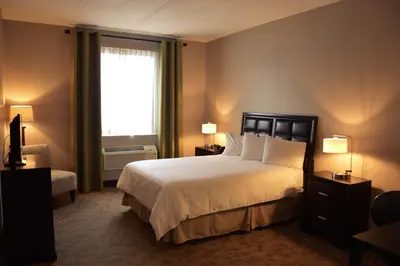 a hotel room with a bed and a window at Belvedere Inn Schenectady - Albany in Schenectady