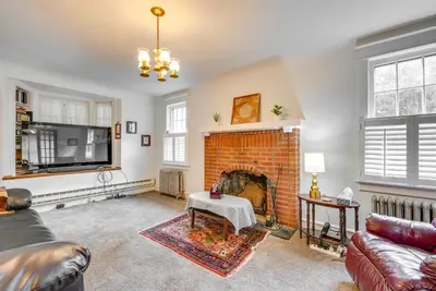 a living room with a brick fireplace and a tv at 8 Mi to Elk Mountain Ski Resort Clifford Home! in Clifford