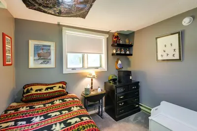 a bedroom with a bed and a desk and a window at West Dover Home - Steps to Mount Snow Resort! in West Dover