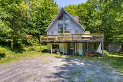 a house with a large deck on the side of it at West Dover Home - Steps to Mount Snow Resort! in West Dover