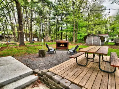 a wooden deck with a fire place in a park at Wally's House in Hawley