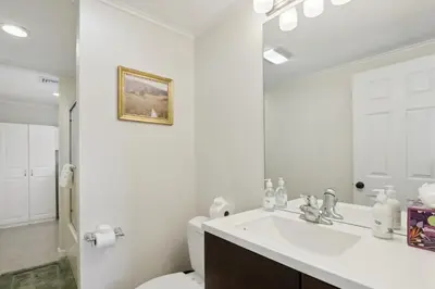 a bathroom with a sink and a toilet and a mirror at Connecticut Retreat Steps to Historic Downtown! in Litchfield