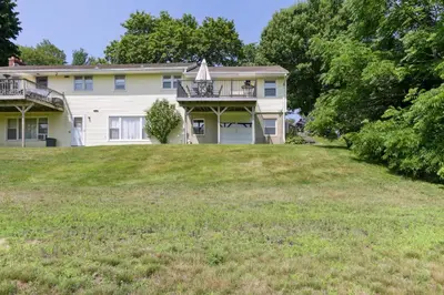 a house on a hill with a large yard at Connecticut Retreat Steps to Historic Downtown! in Litchfield