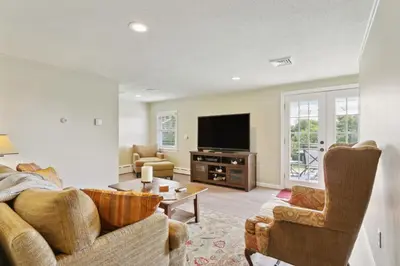 a living room with a couch and a tv at Connecticut Retreat Steps to Historic Downtown! in Litchfield